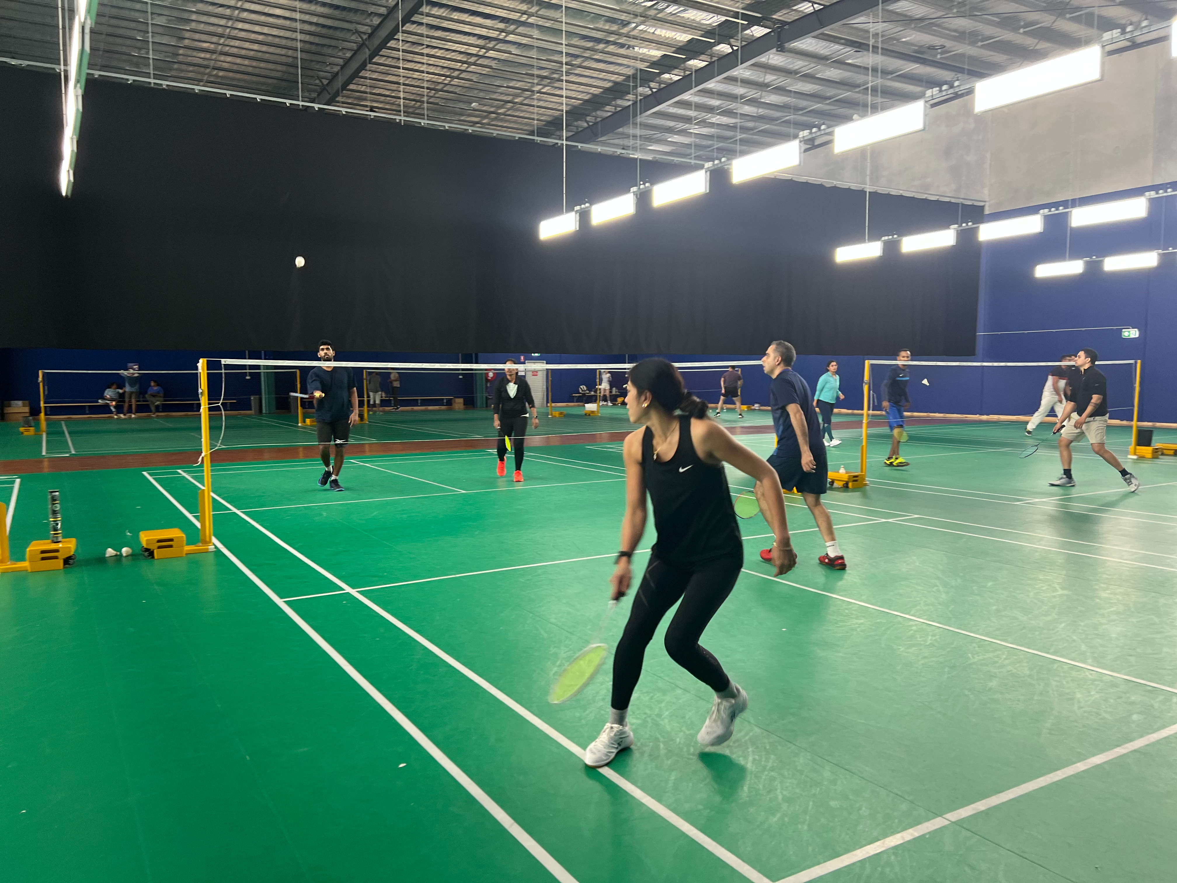 Tuesday badminton socials players in a doubles rally